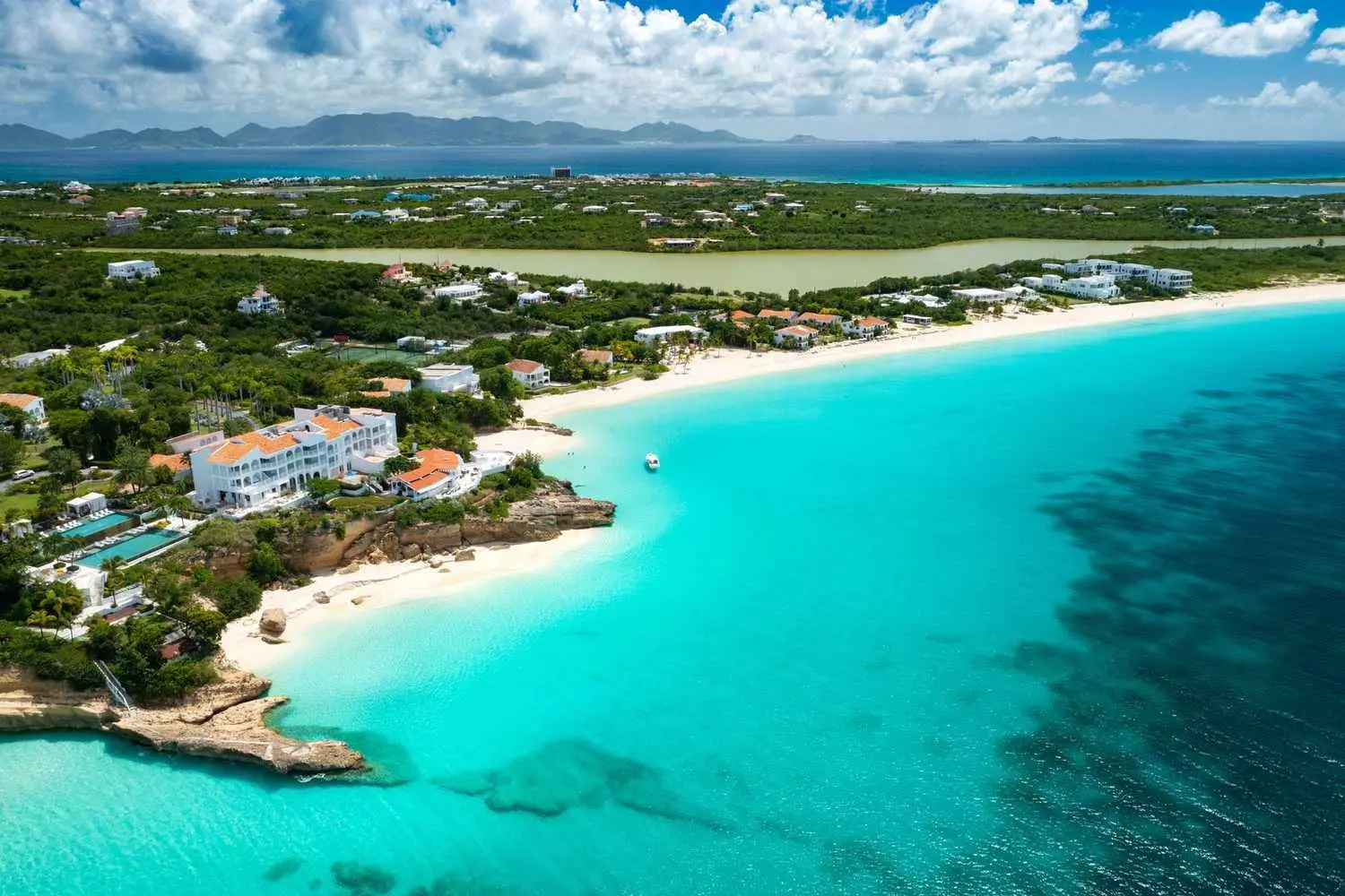 Anguilla from the air: a long white beach, a salt pond and the turquoise shallows