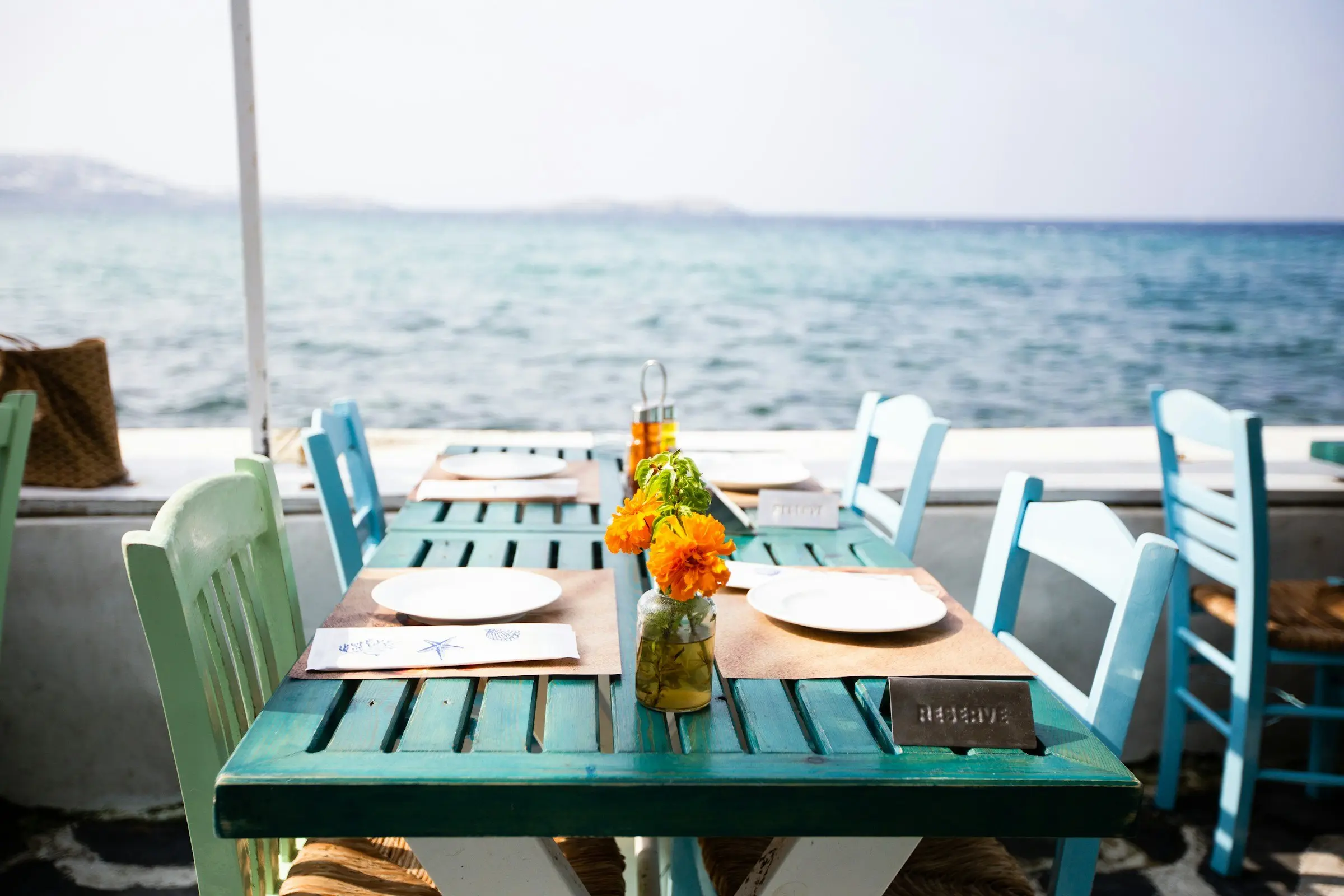A table laid on a boat deck, the open sea behind